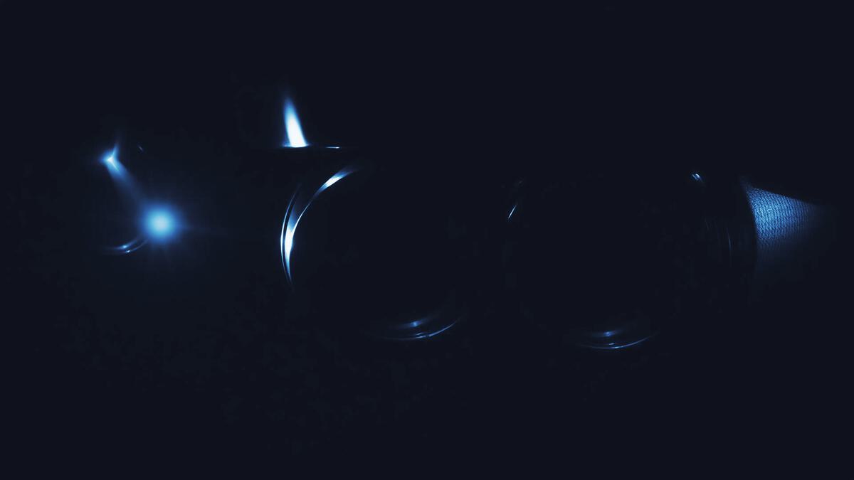 Exhaust tailpipes of a diesel car in low light