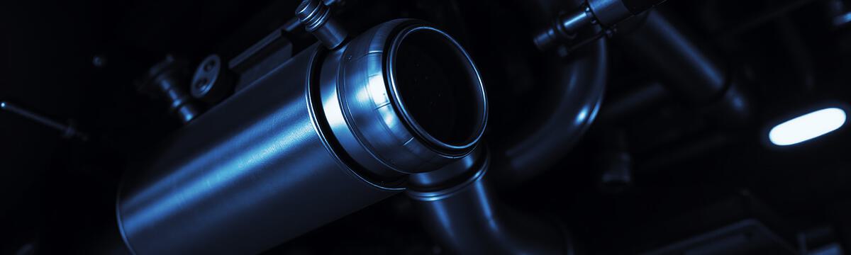 Close-up of exhaust pipework where a diesel particulate filter sits